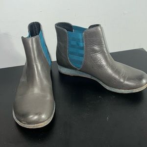 Olive green and teal round toe booty with a tiny wedged heel.